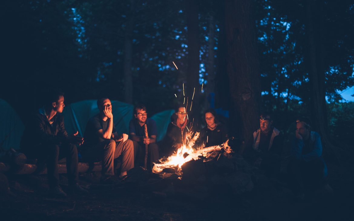 Campers sit around a camp fire at Algonquin Park in Canada
