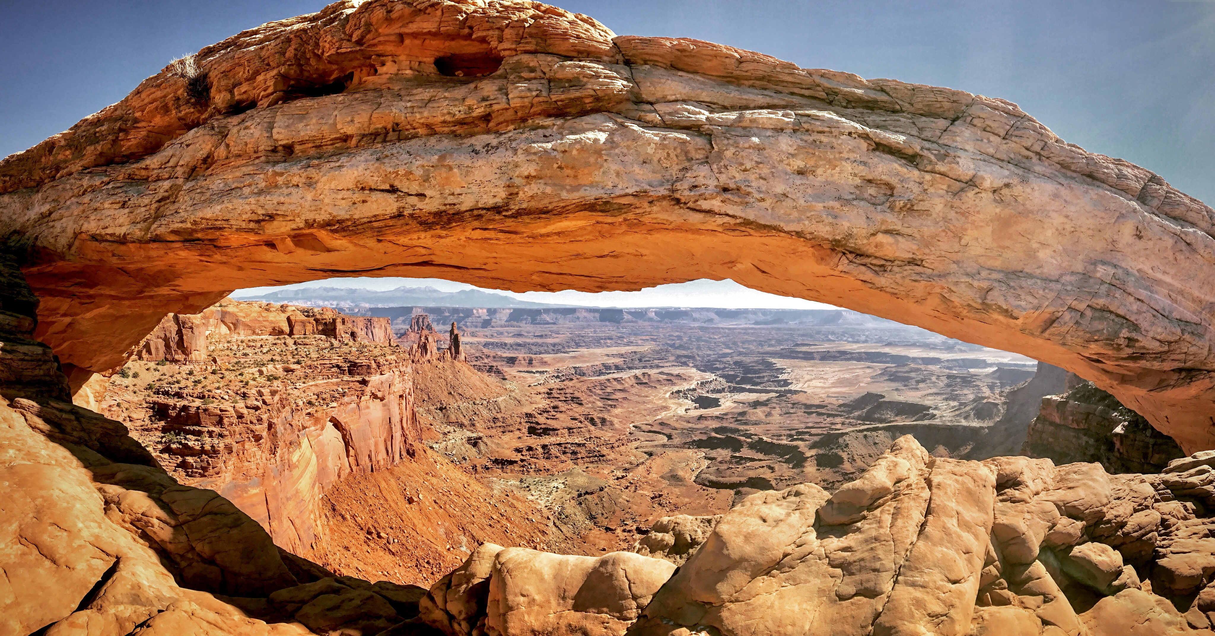 Rock arch stretches across desert enivronment