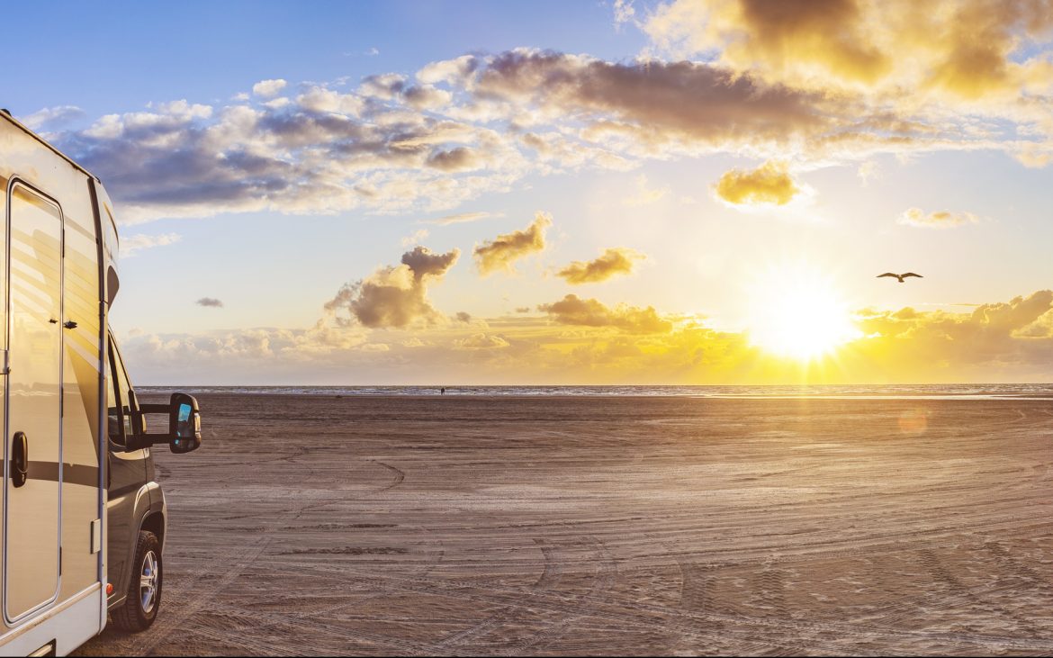 Motorhome facing the ocean at sunset