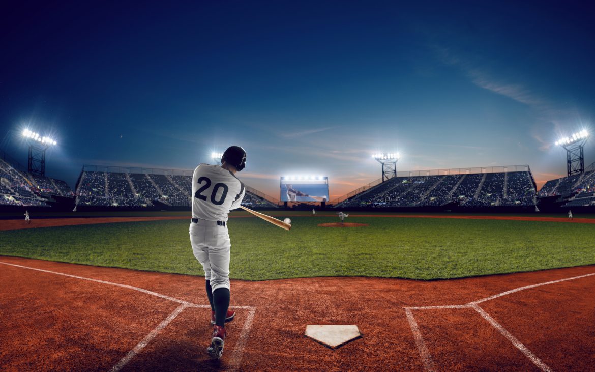 A baseball hitter swinging with view toward the outfield