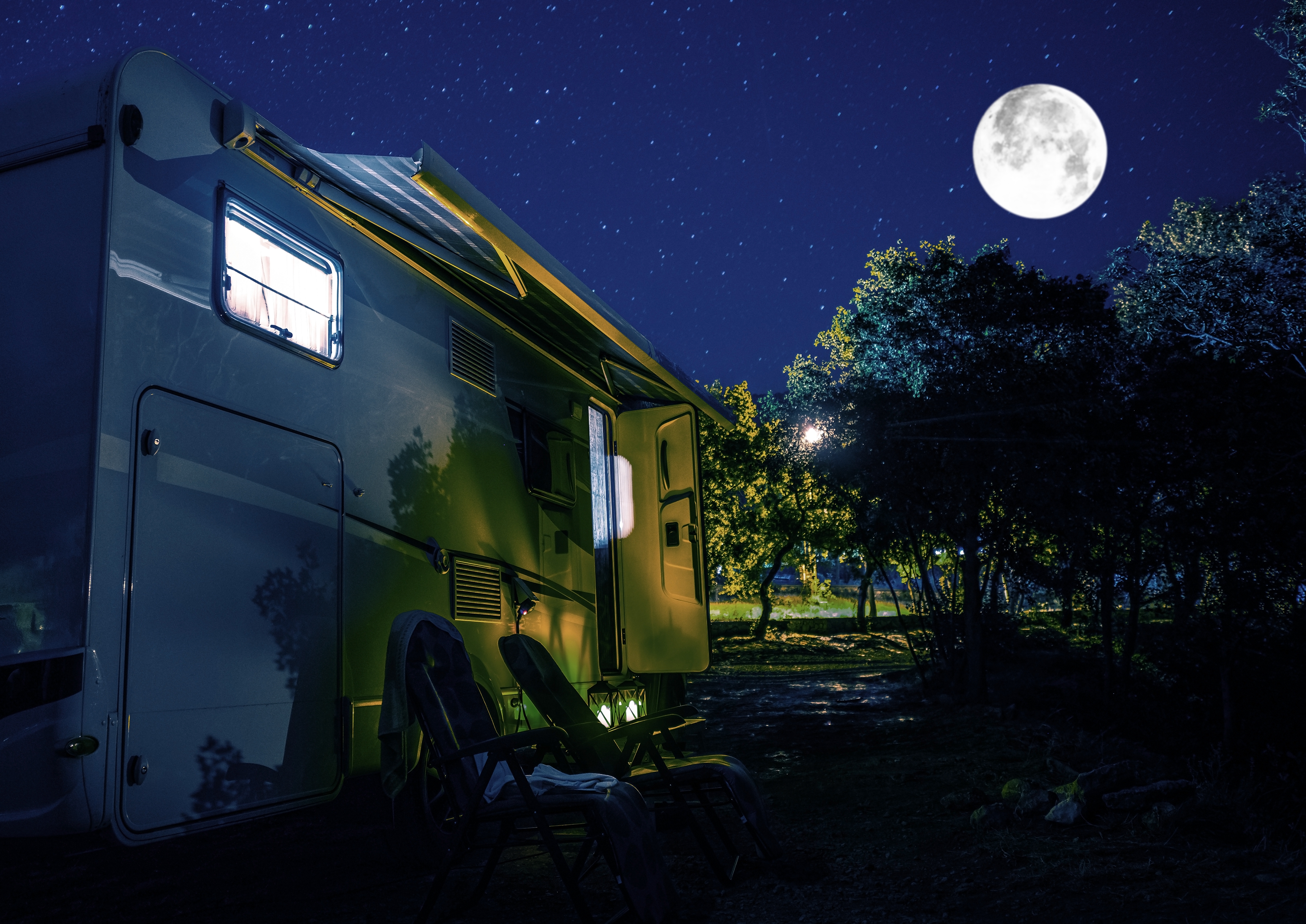 Summer Night RV Camping. Recreational Vehicle Class C Motorhome Under Starry Sky. Campground RV Park Pitch. Modern Camper Van.