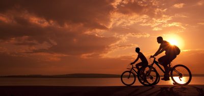 A pair of riders during sunset.