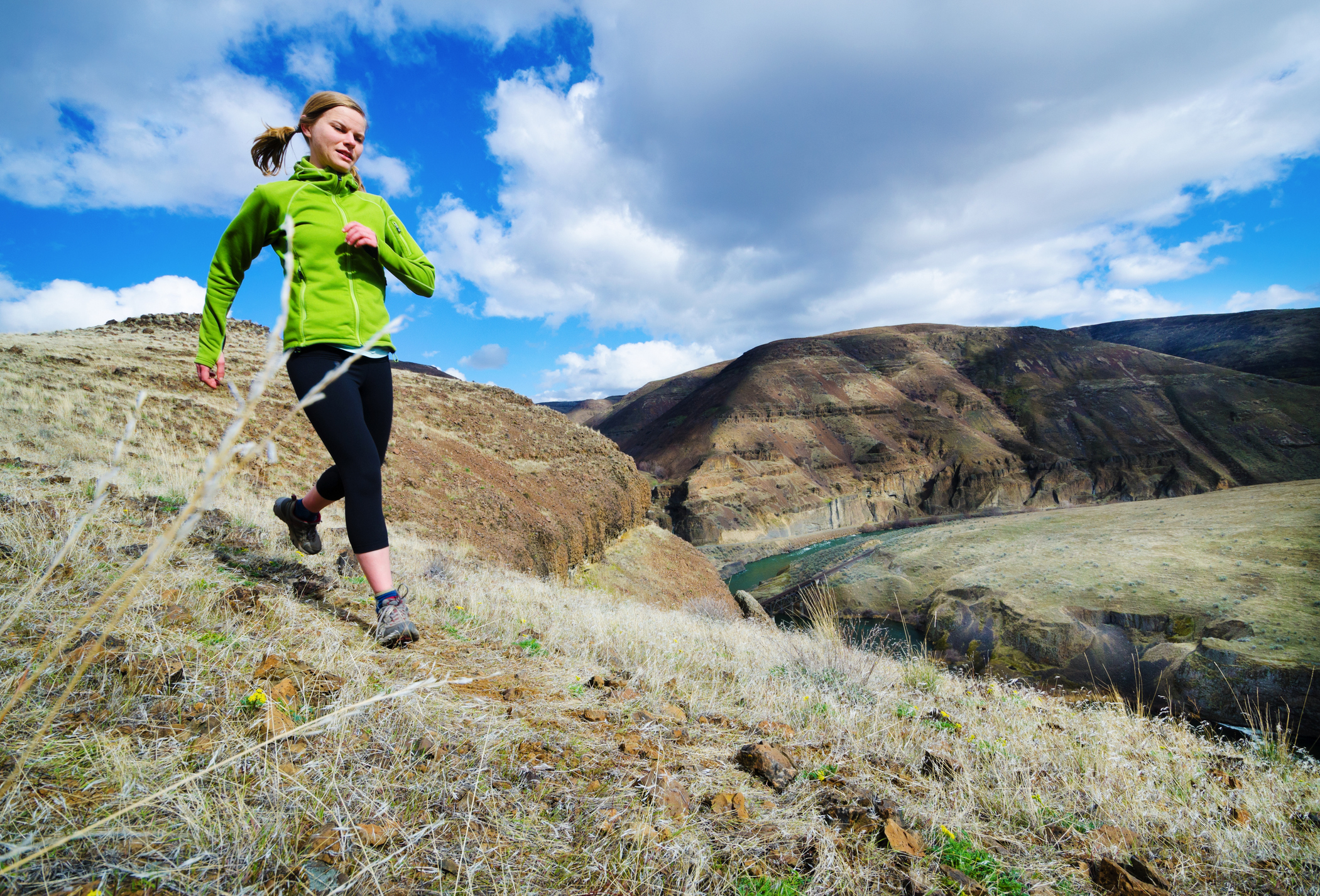 A woman runs across a ridge in the high desert of Central Oregon.