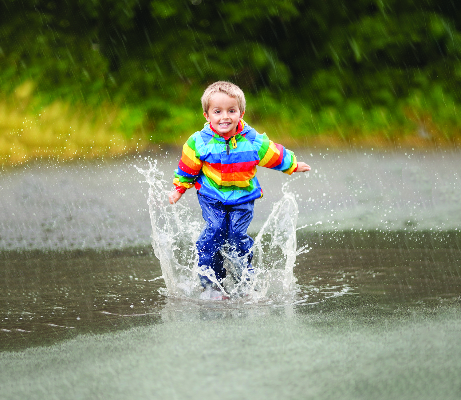 Keep Kid Entertained During rain — A kid jumping up and down in a puddle