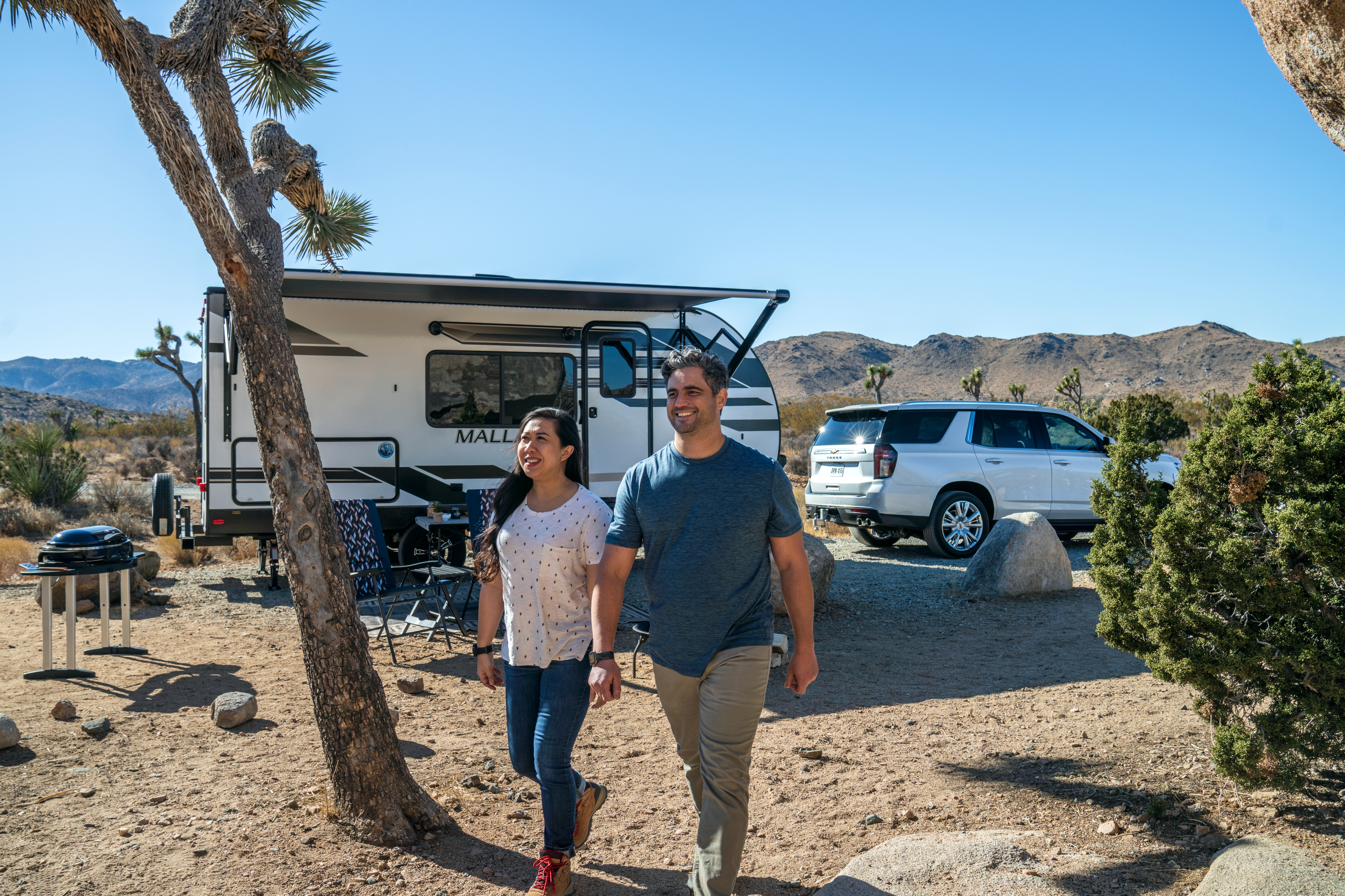 Taking your new RV out -- A couple embarks on a stroll through their campsite.