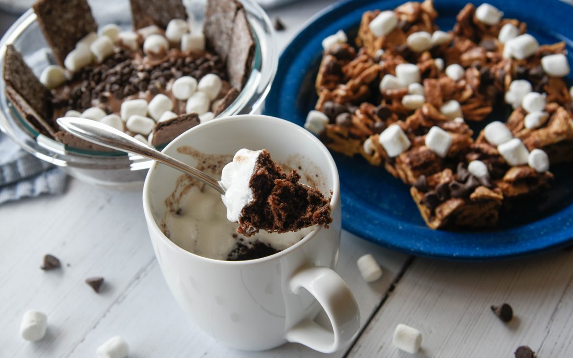A cup of gooey cake with s'mores bars and dip