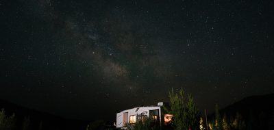 Picking the perfect campsite in Colorado — A fifth-wheel camping under a starry night sky.
