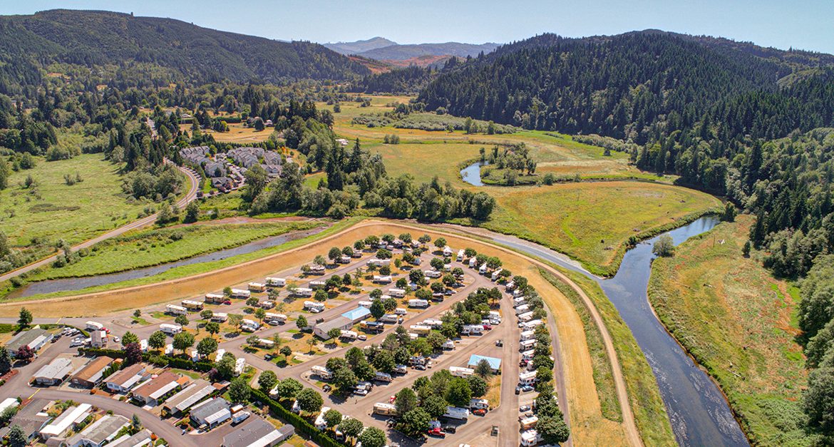 Brookhollow RV Park is a well-kept secret — Aerial shot fo an RV park on the banks of a river.