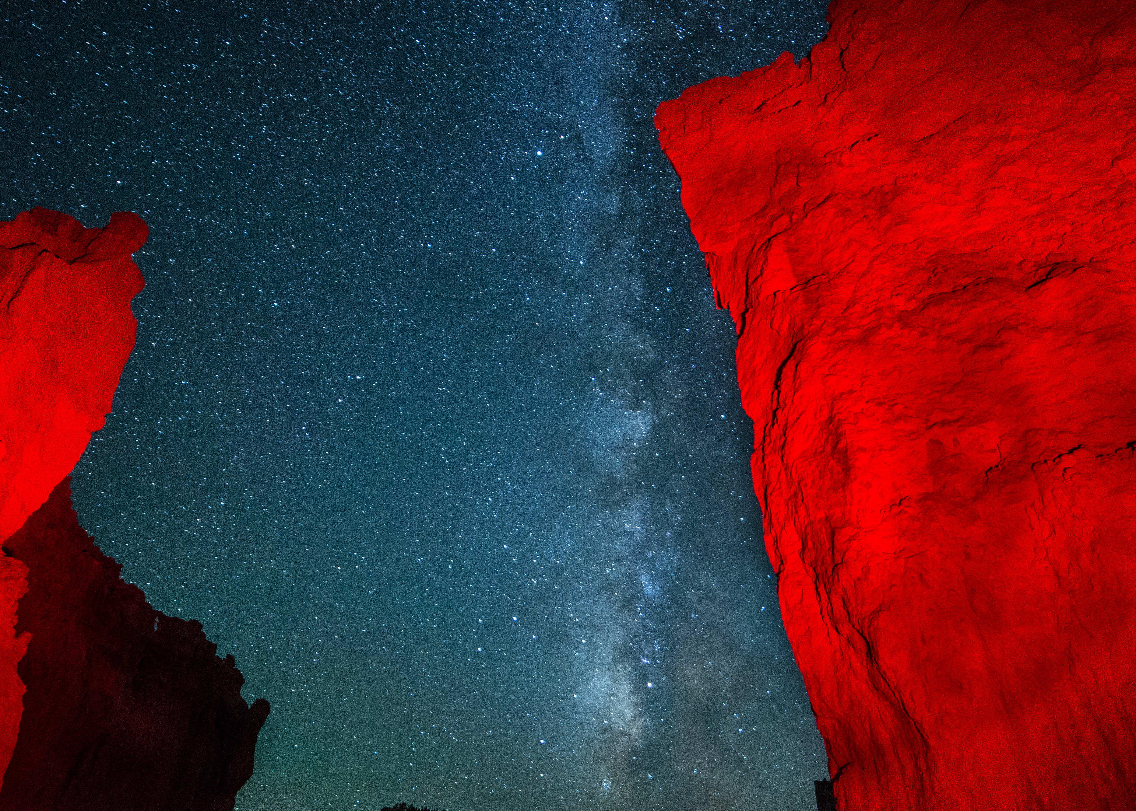 Orange hoodoo against a night sky with the Milky Way