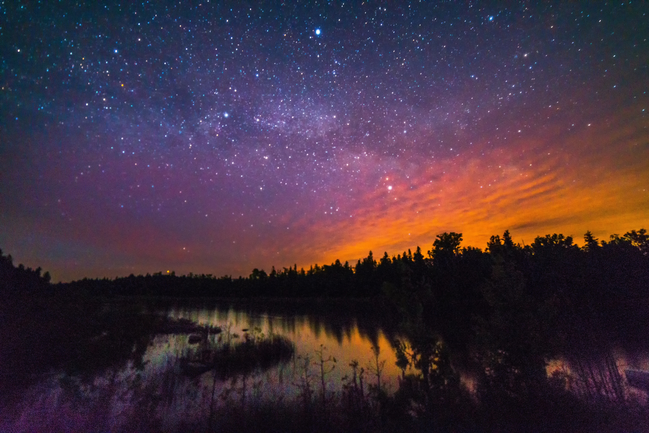 Starry skies bathed in reddish light.