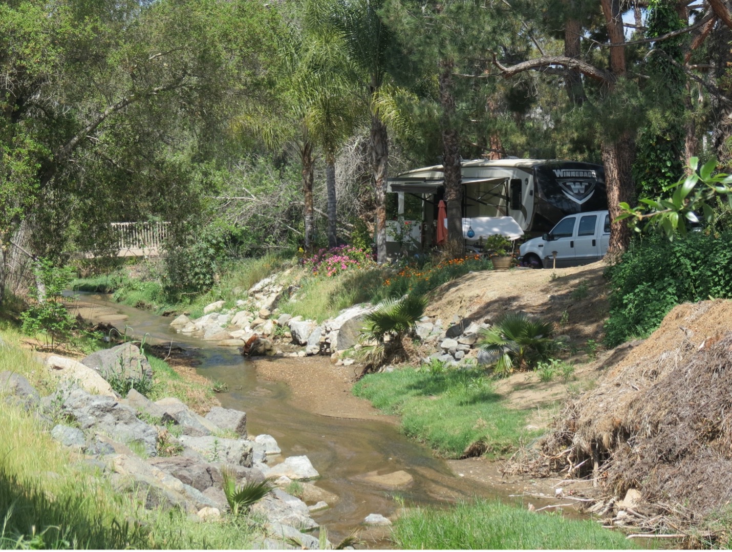 RV site overlooking stream.