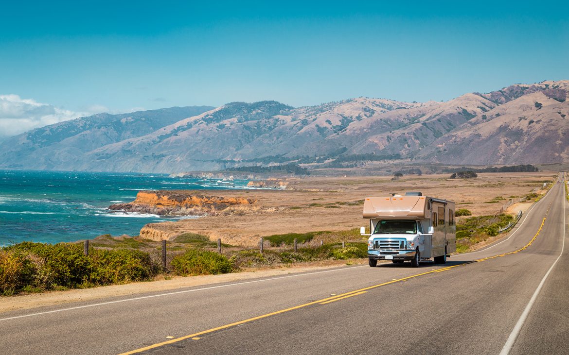 spring trip — Motorhome driving along a coastal road.