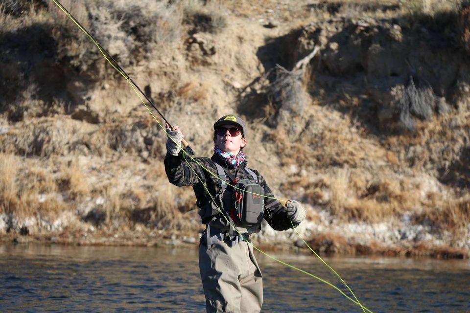 Woman preparing to cast a line during fly-fishing.