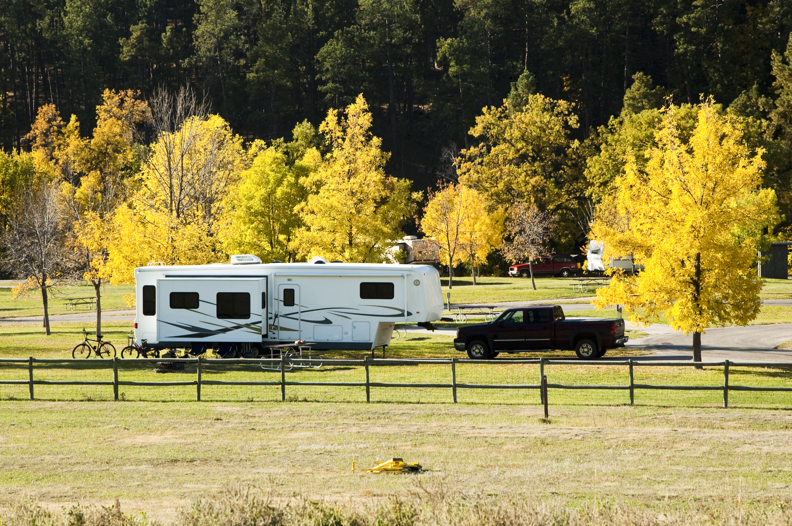 Fifth-whell trailer in a scenic campground.