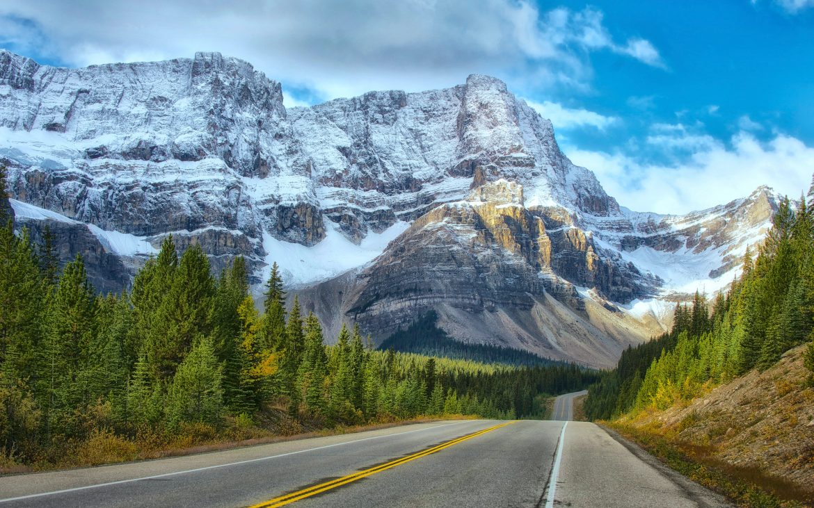 Highway leading to snowy mountain in Banff Canada