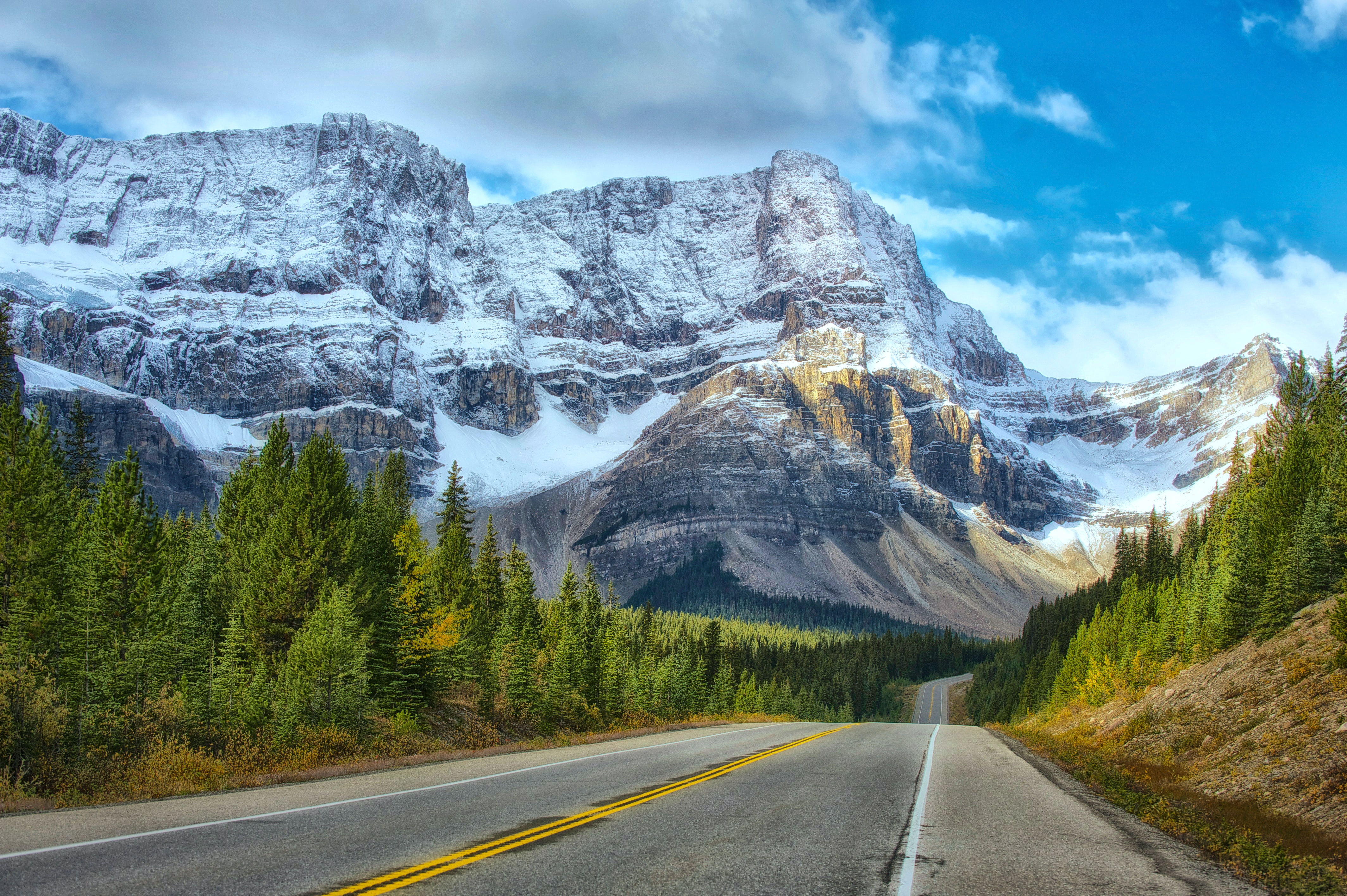 Highway leading to snowy mountain in Banff Canada
