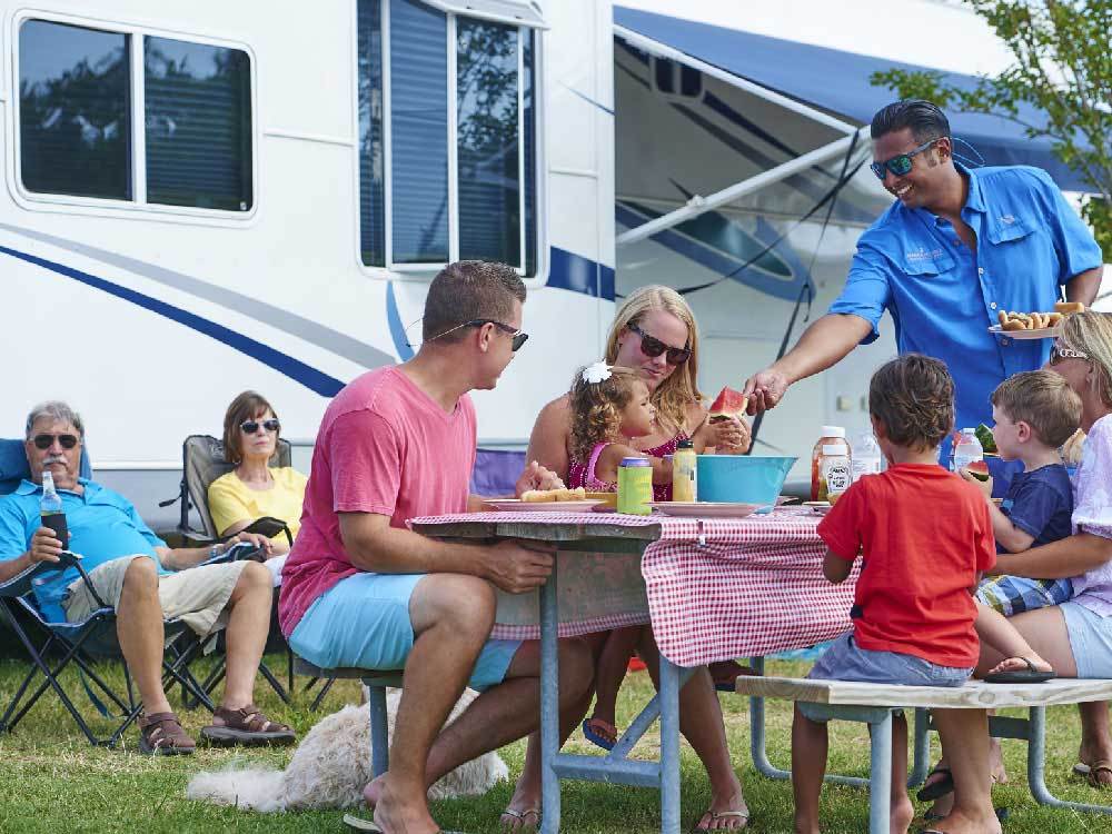 A family gathered around a picnic table. 