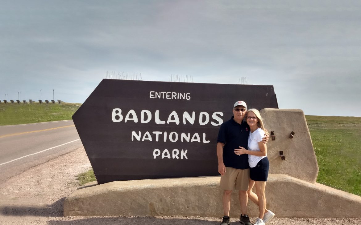 Call of the highway — a couple standing in front of a Badlands sign