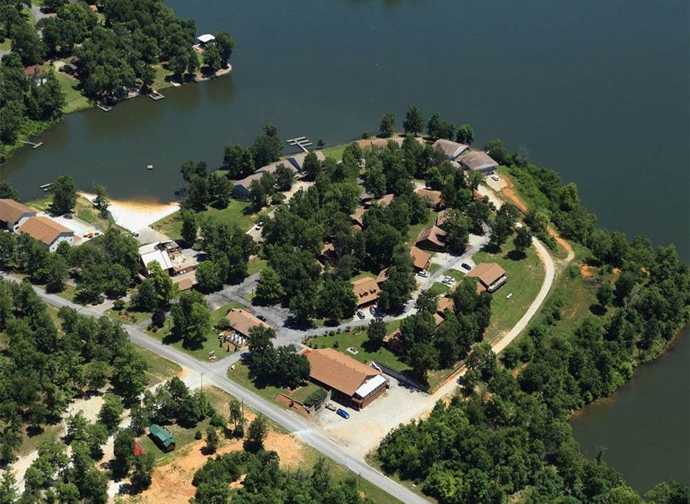 Peaceful Lakeside Retreat —Aerial view of campground on a lake.
