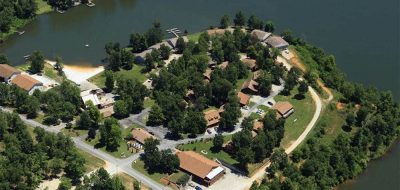 Peaceful Lakeside Retreat —Aerial view of campground on a lake.