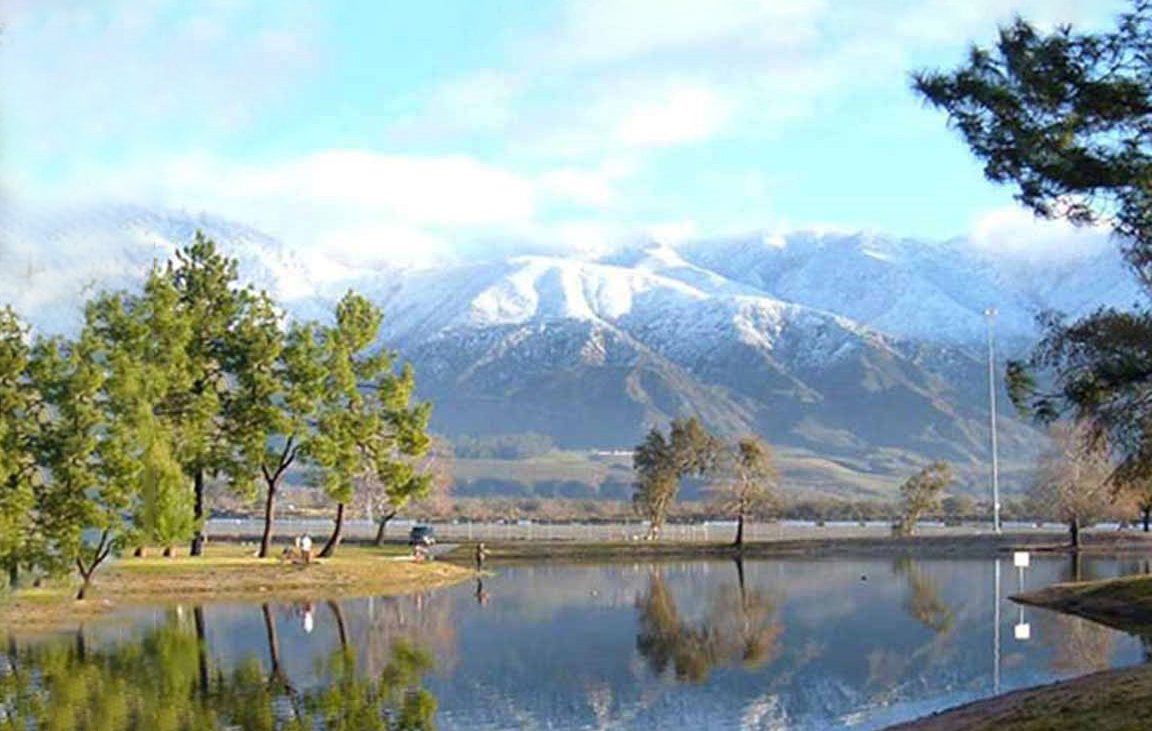 perfect getaway in San Bernardino County — mountains on the horizon reflected in a tranquil lake.