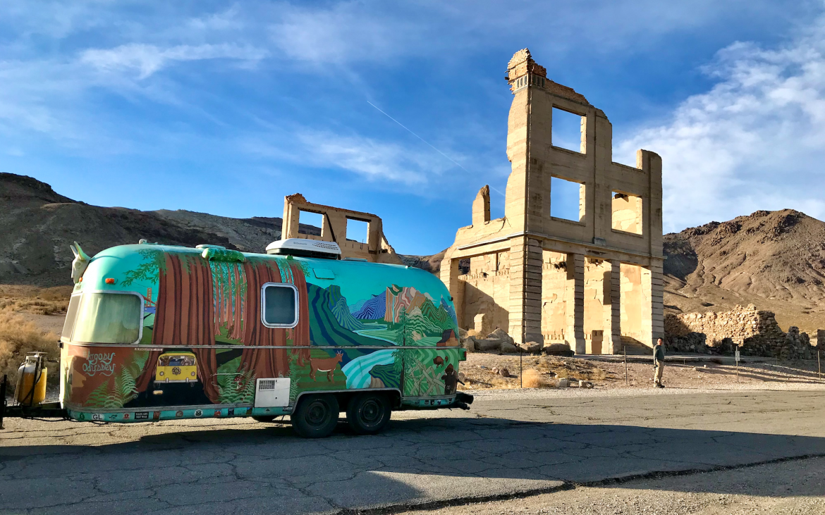 painted airstream in front of Cook Bank, the tallest building in Rhyolite.