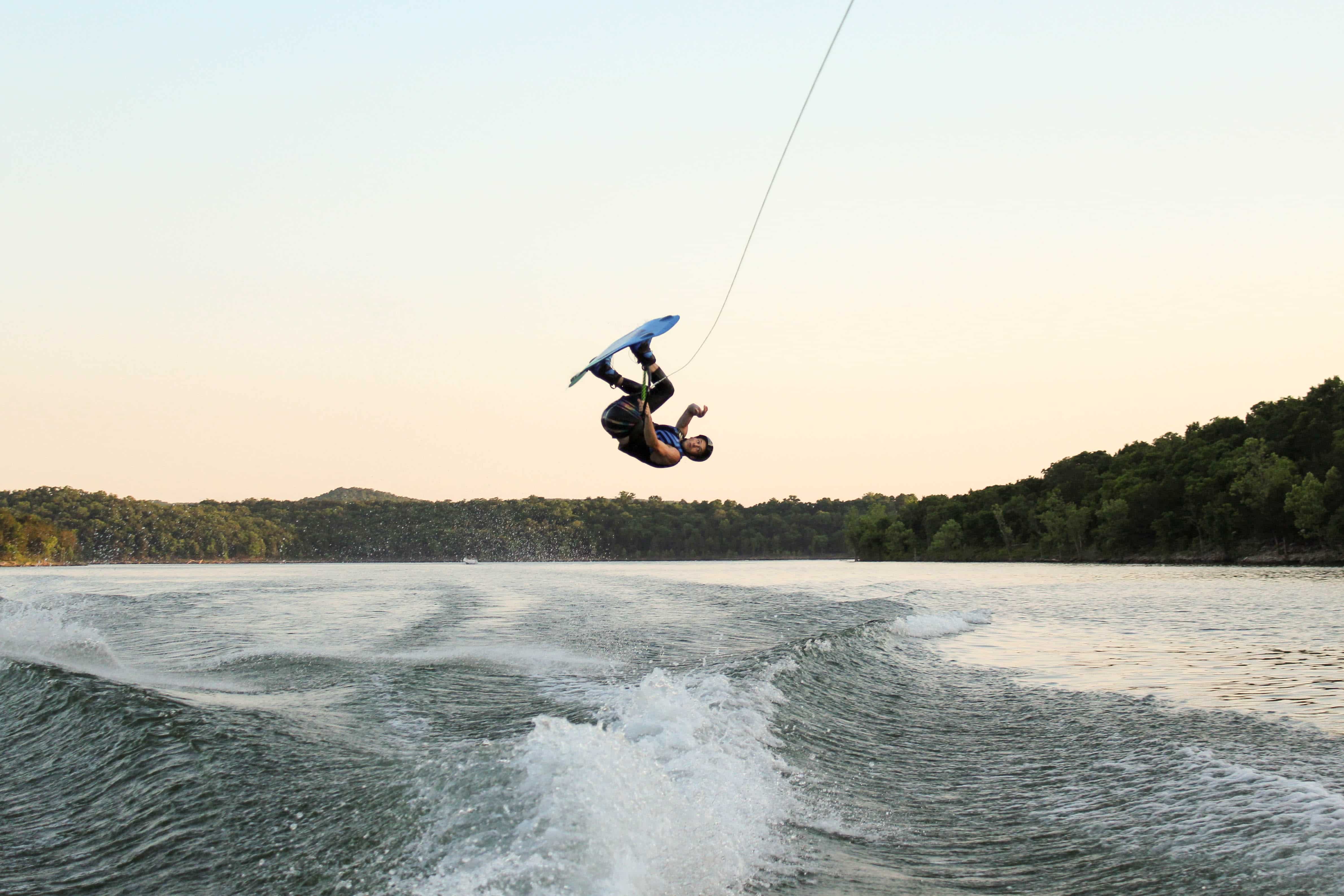 Man wakeboarding in the wake of a motorboat.