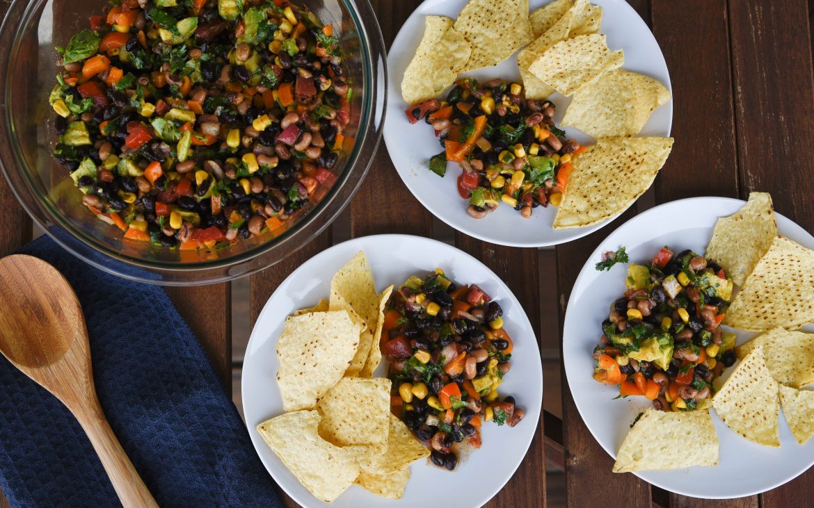 beans, black eyed peas, onion, tomatoes, corn, bell pepper, cilantro mixed together in bowl