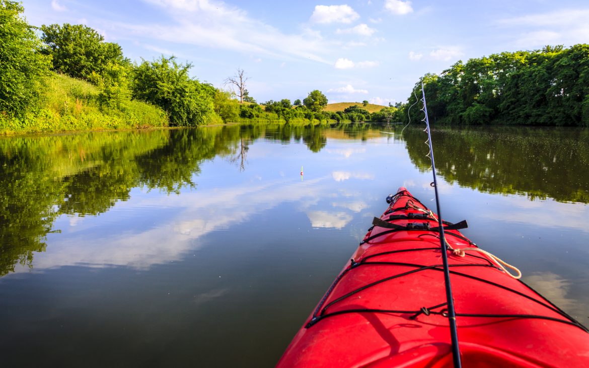 Gulf Coast Kayak Fishing — Red kayak wifh fishing poles