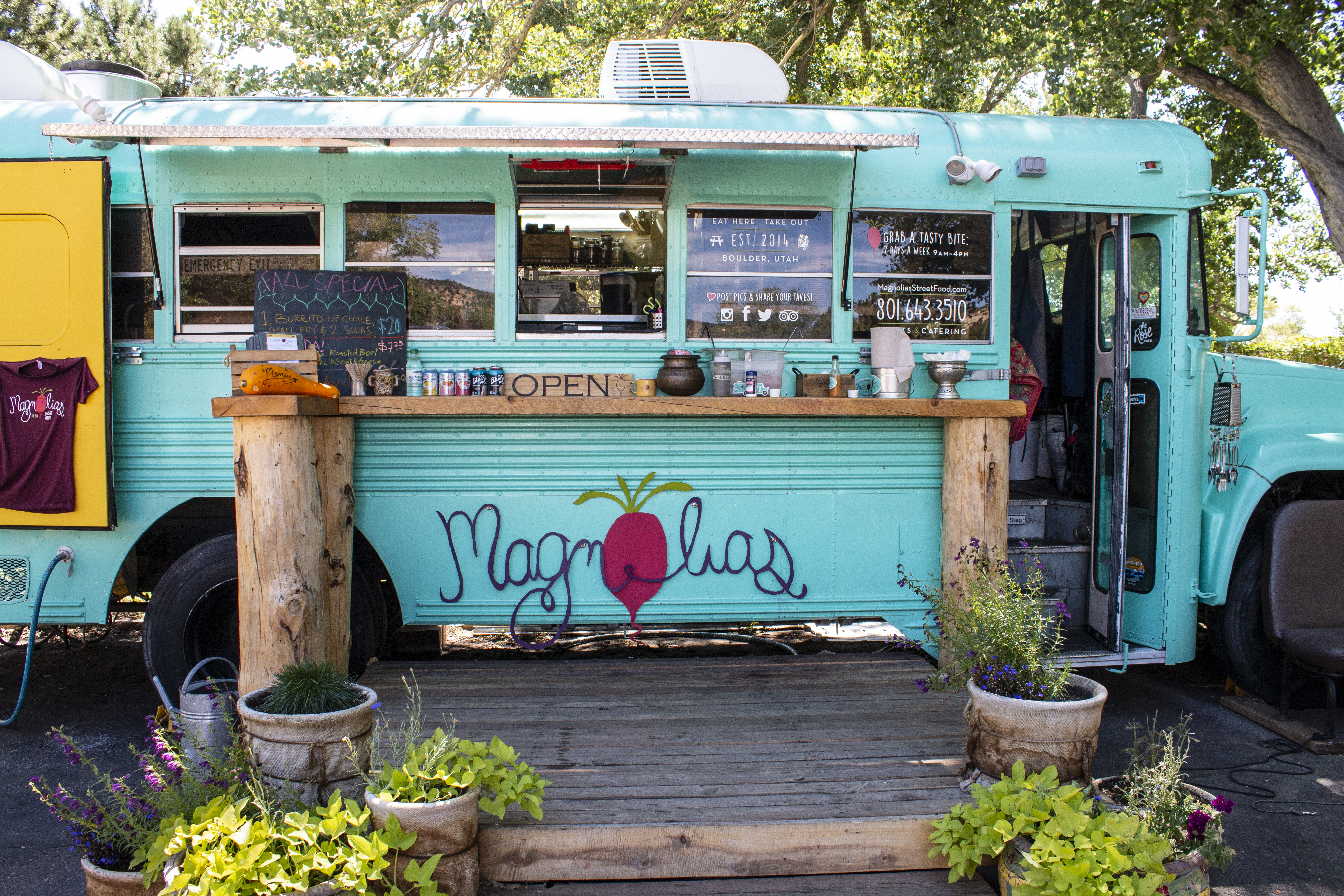 Aqua-colored school bus converted to food truck and named "Magnolias"