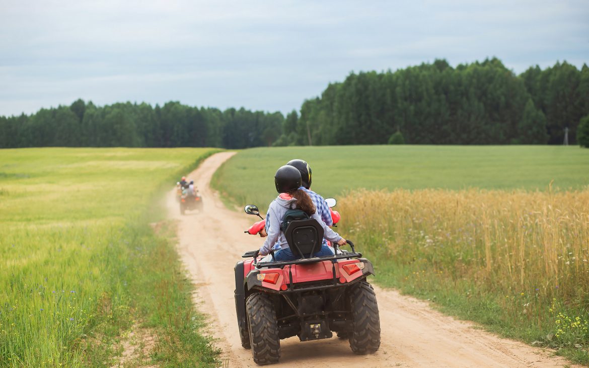 Good Sam Has Added 21 New Parks An ATV Quad sets out on a dusty trail toward a forest.