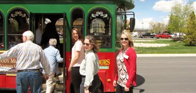 Cody in Wyoming — Passengers board a red and green trolley