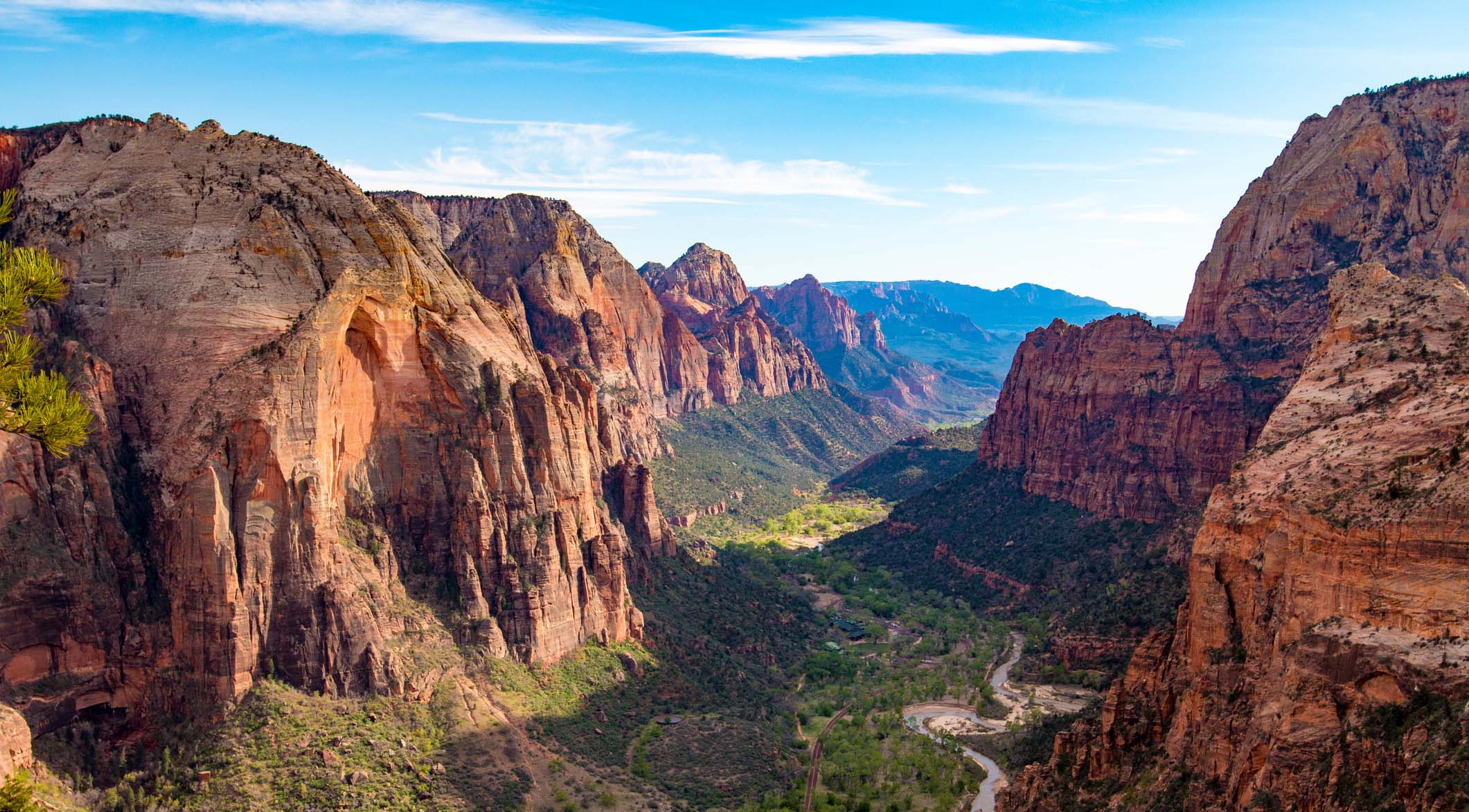 A view of a majestic valley with golden cliffs.