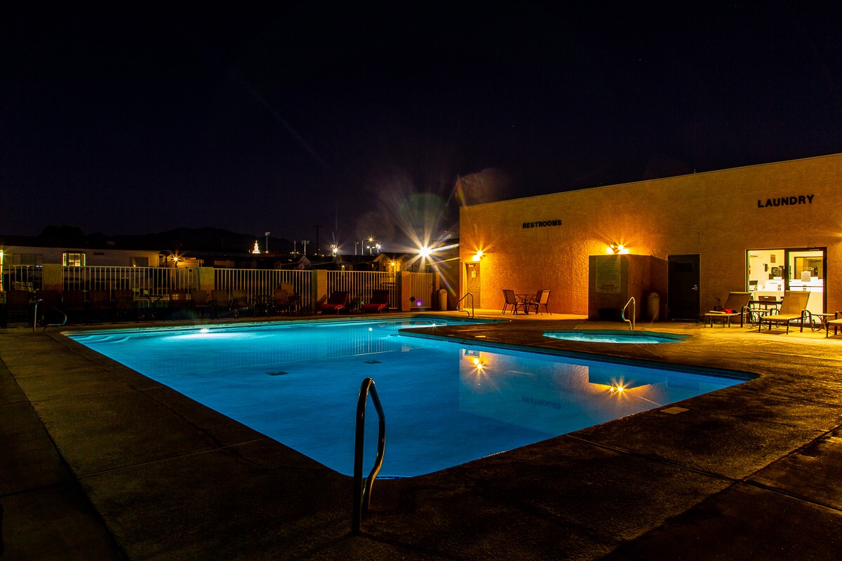 A pool illuminated by soft lighting during the evening.