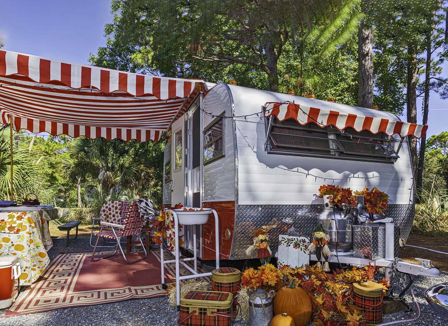 A vintage trailer festooned in autumn-Halloween decor.