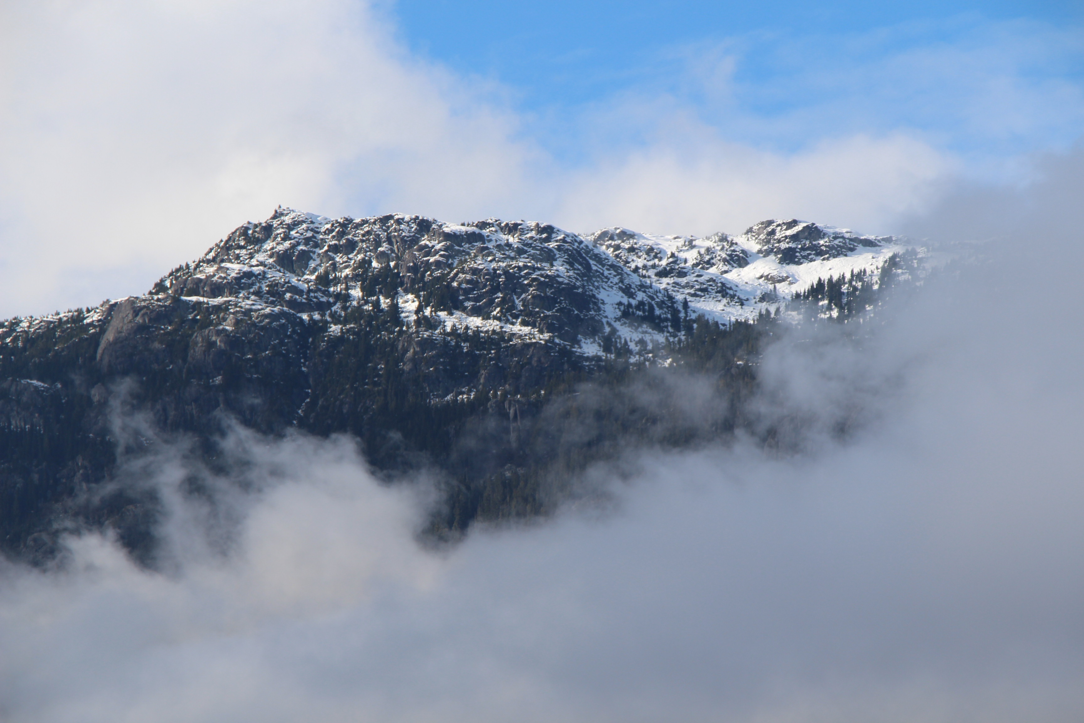 A high mountain peak wreathed in fog.