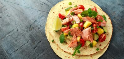 Kid-friendly recipes — Salmon fish tacos with mango, avocado, tomato, spring onion and lime. Mexican food