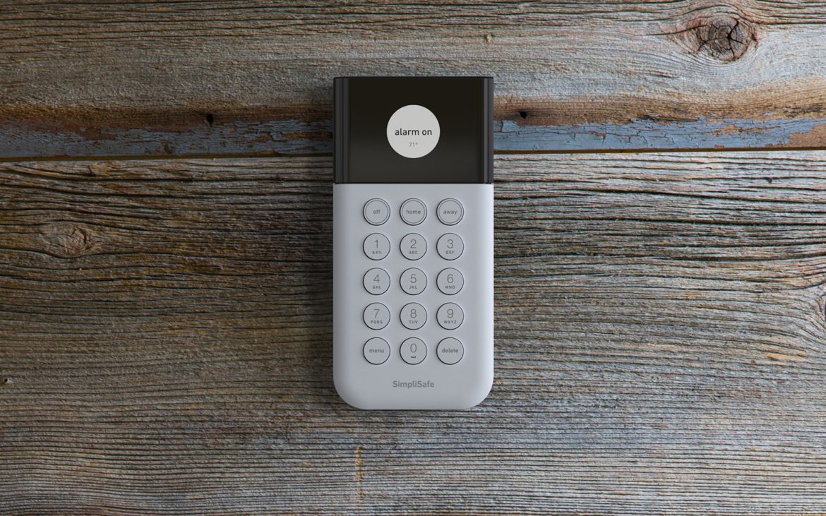 Keypad mounted on wooden wall.