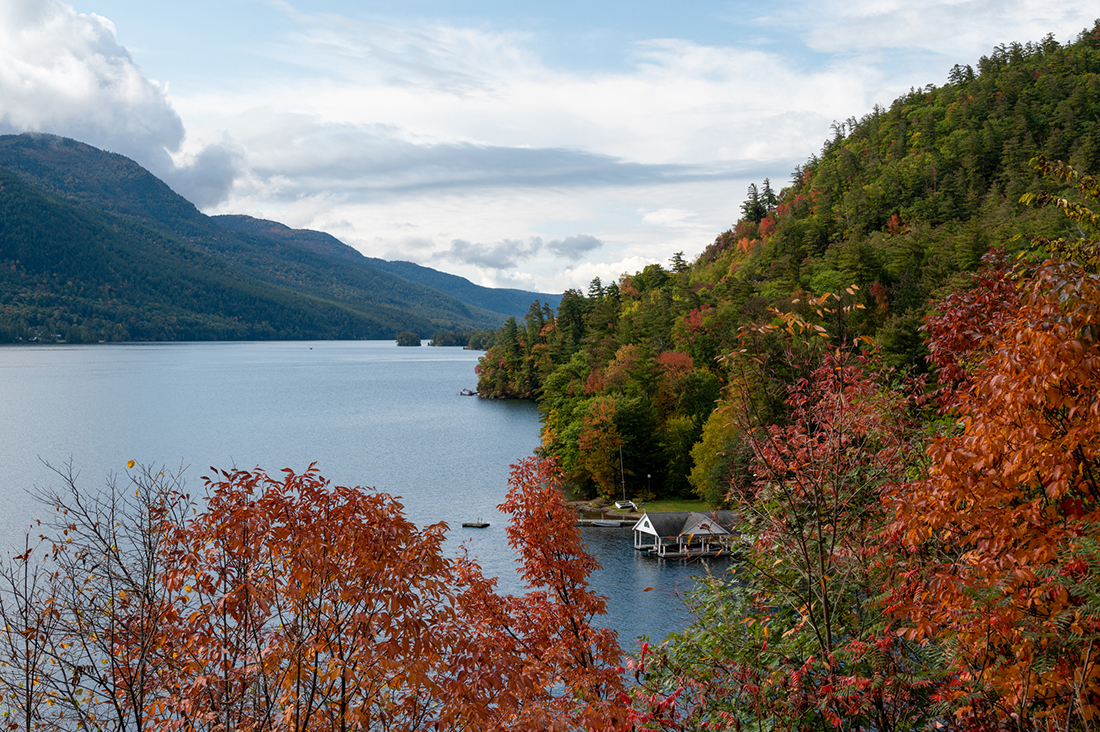 Lake fringed by golden trees.