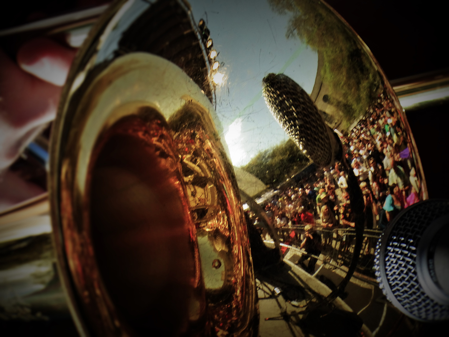 Crowd reflected in a trombone.