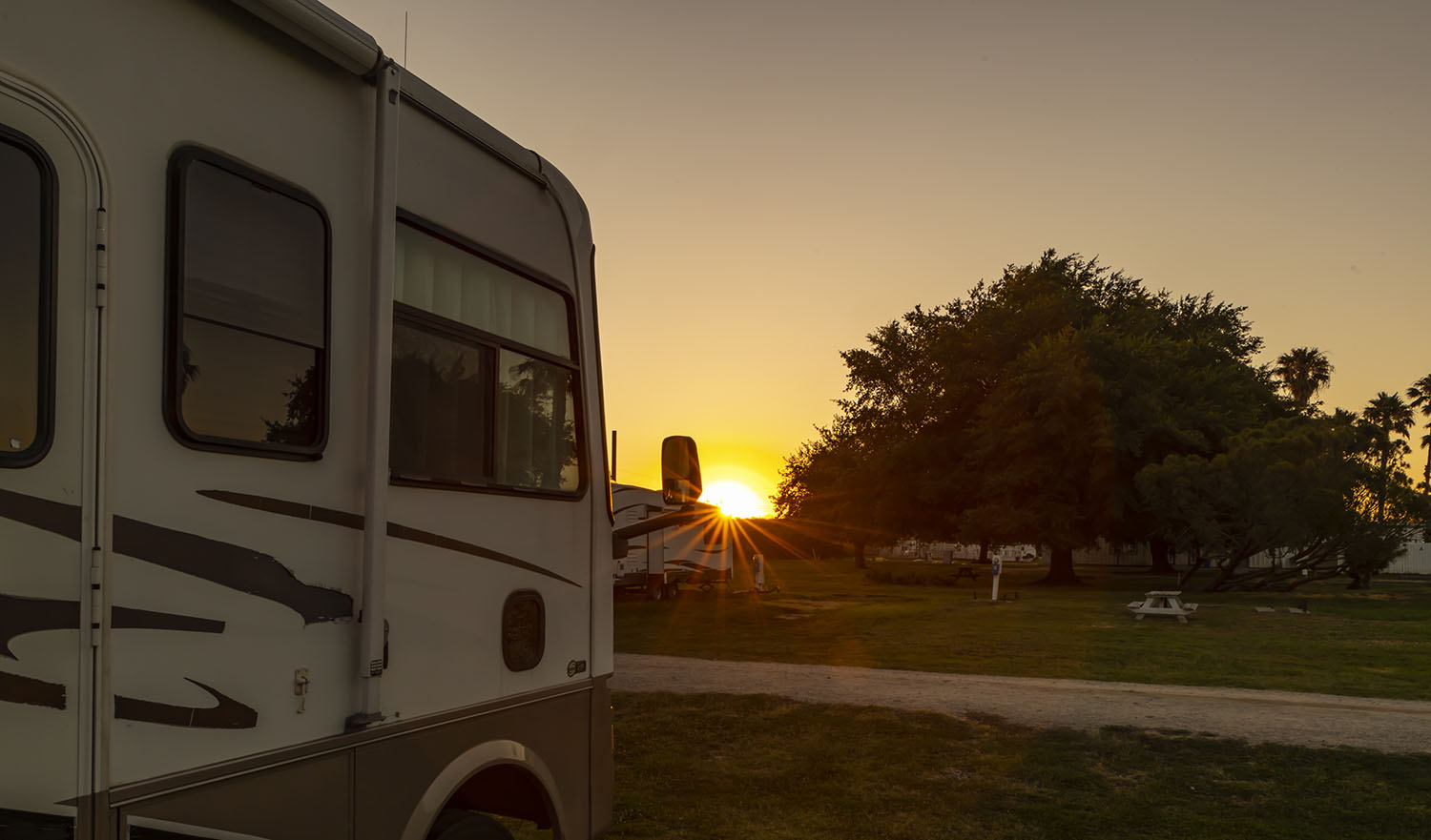 Motorhomes parked in campgrounds at sunrise on nice sunny days
