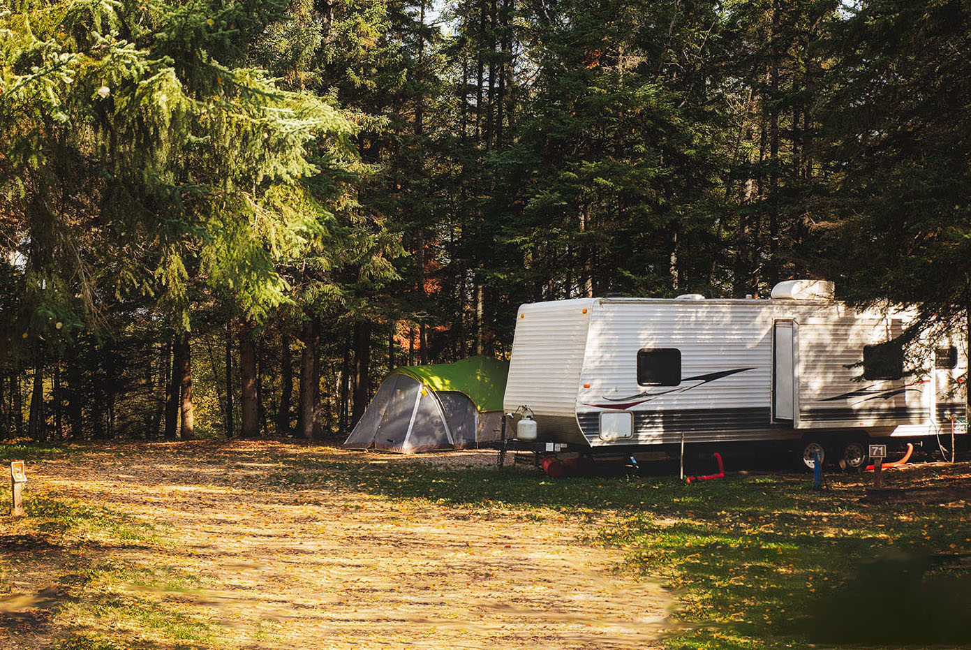 Travel trailer camped out in the woods.