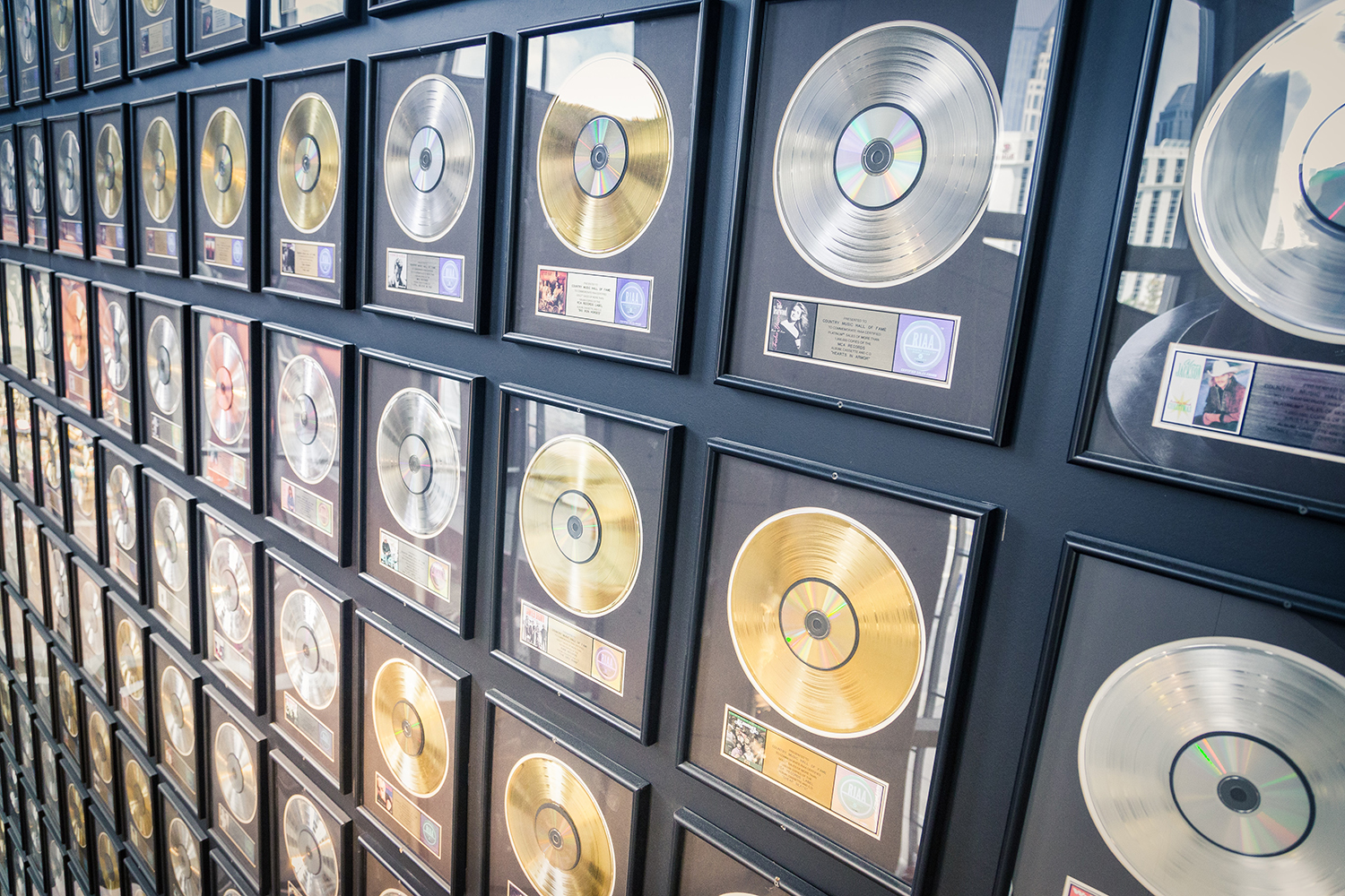 Gold and silver records mounted on a wall.