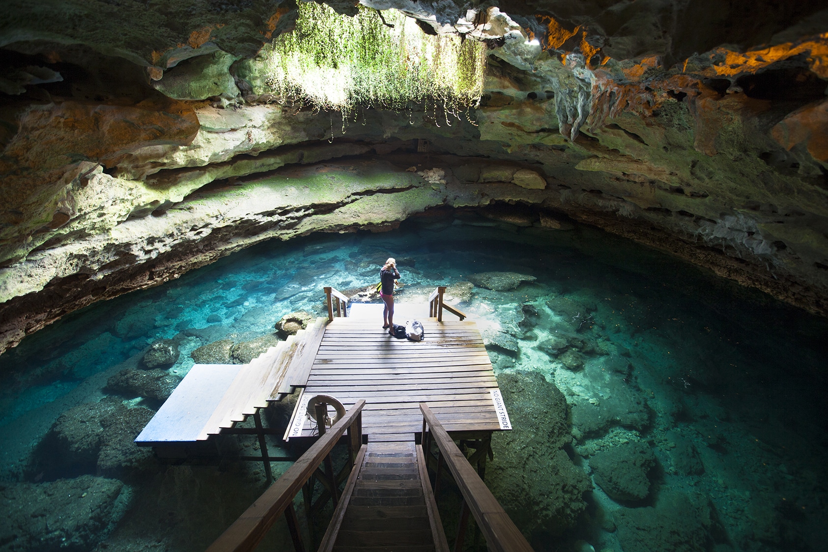 A diver prepares to go under in an underground spring.