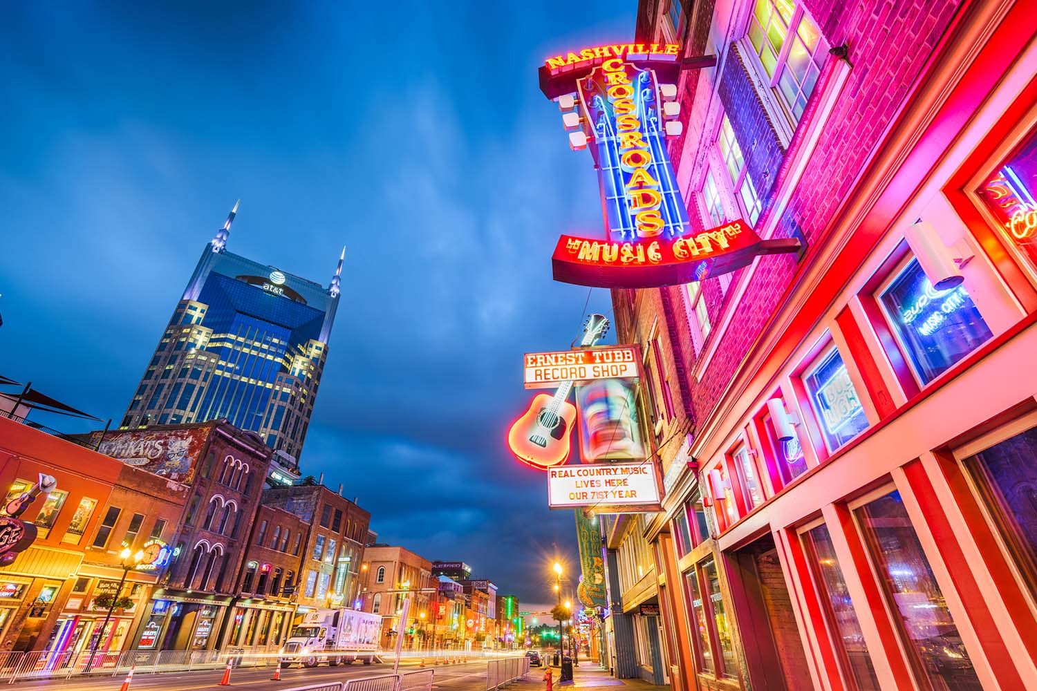 Neon-lit entertainment district in urban area.