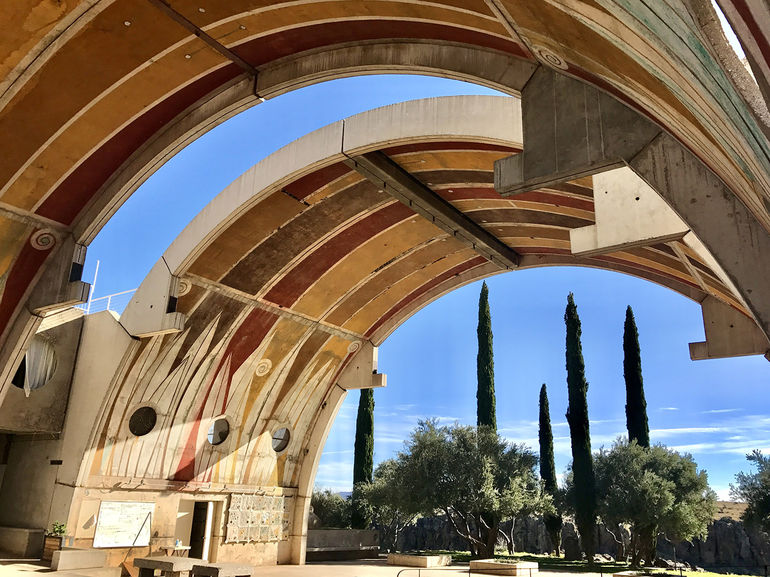 Arch structures with a beige and rust color scheme