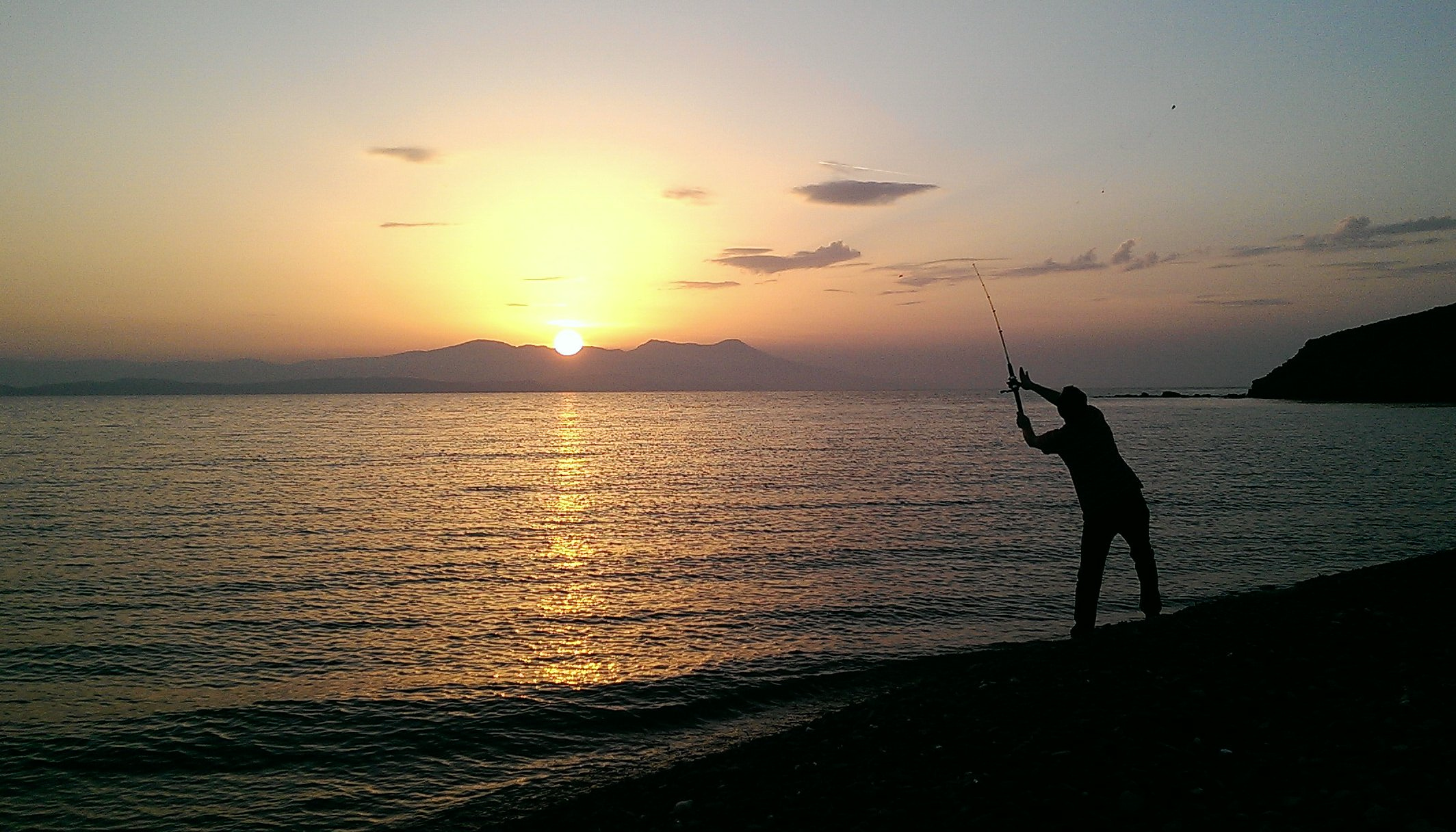 Sunset surf fishing casting.
