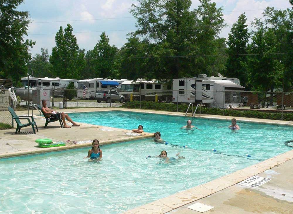 Camping swimming in an L-shaped pool in an RV park.