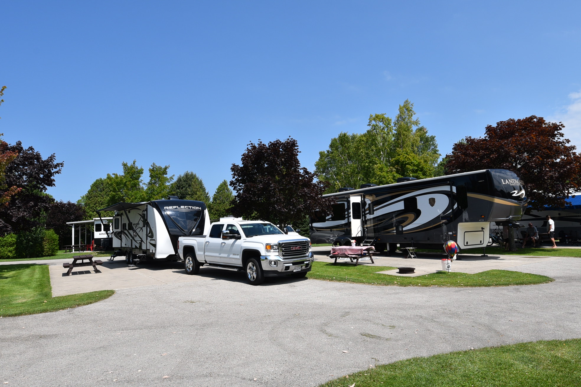Travel Trailer and Fifth-wheel in adjacent spaces.