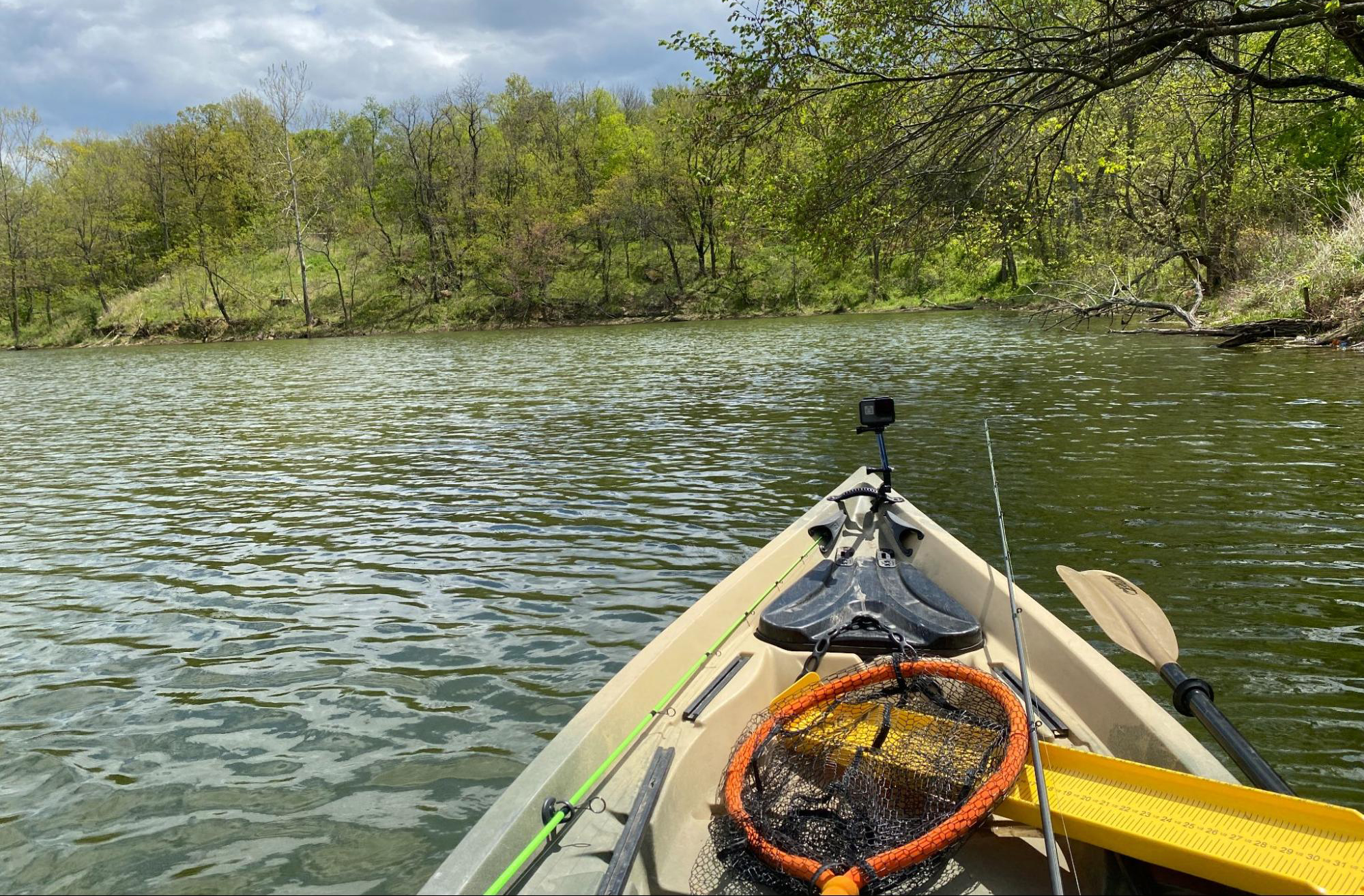 Bow of a kayak as it cuts through a pond or lake.